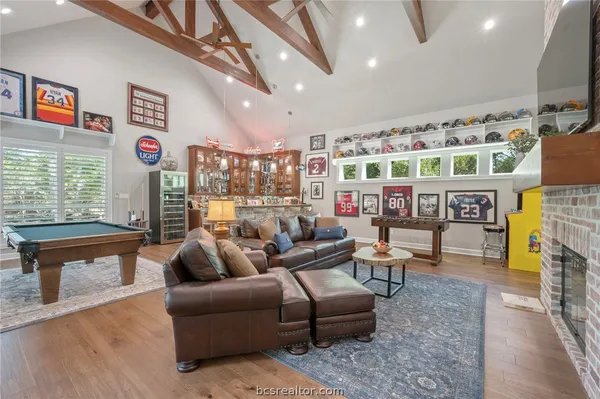 a living room with furniture a window and a flat screen tv
