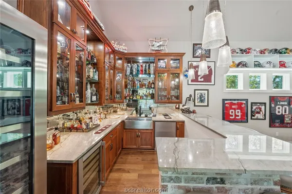 a view of a kitchen with stainless steel appliances granite countertop a stove and a large window