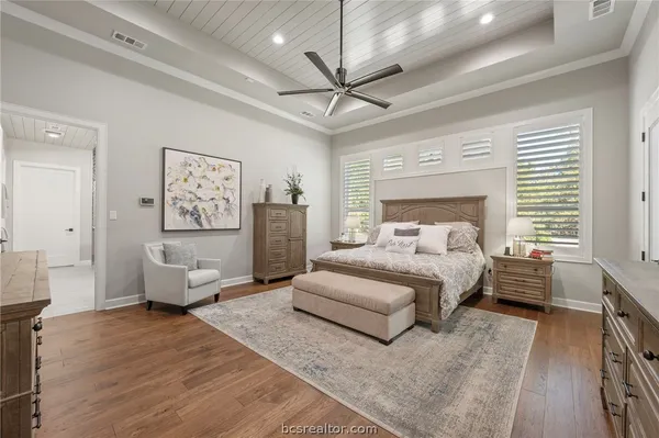 a bedroom with a bed couch and a window