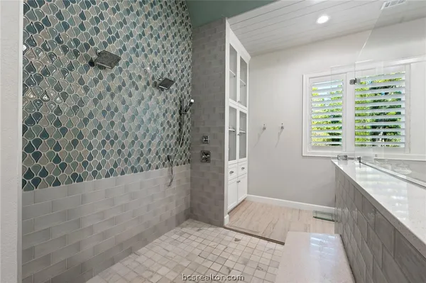 a view of bathroom with bathtub and shower