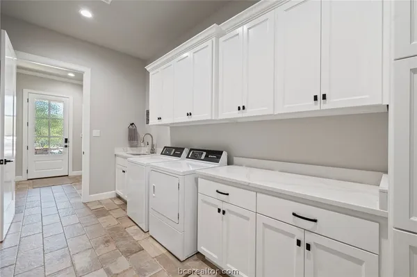 a kitchen with stainless steel appliances white cabinets and a sink