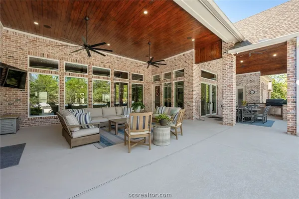a view of a patio with dining table and chairs