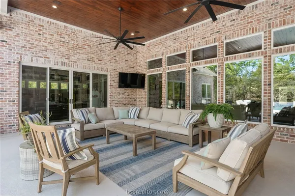a outdoor space with patio the couches and potted plant with large windows