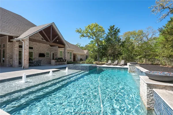 a front view of a house with a garden and patio