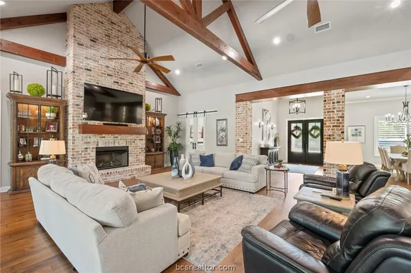 a living room with furniture a fireplace and a flat screen tv