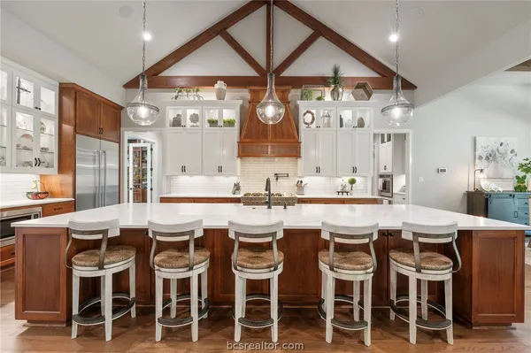 a dining area with a table chairs and a large window