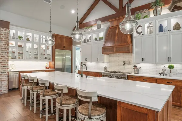 a large kitchen with a table and chairs