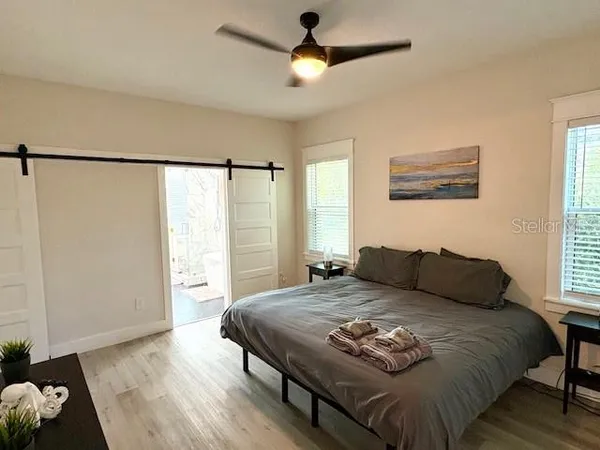 a bedroom with a bed and a window