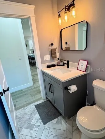 a bathroom with a toilet sink and mirror
