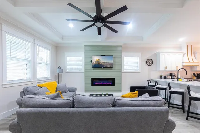 a living room with furniture a fireplace and a flat screen tv