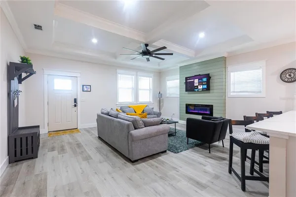 a living room with furniture a fireplace and a flat screen tv