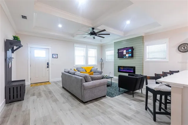 a living room with furniture a fireplace and a flat screen tv