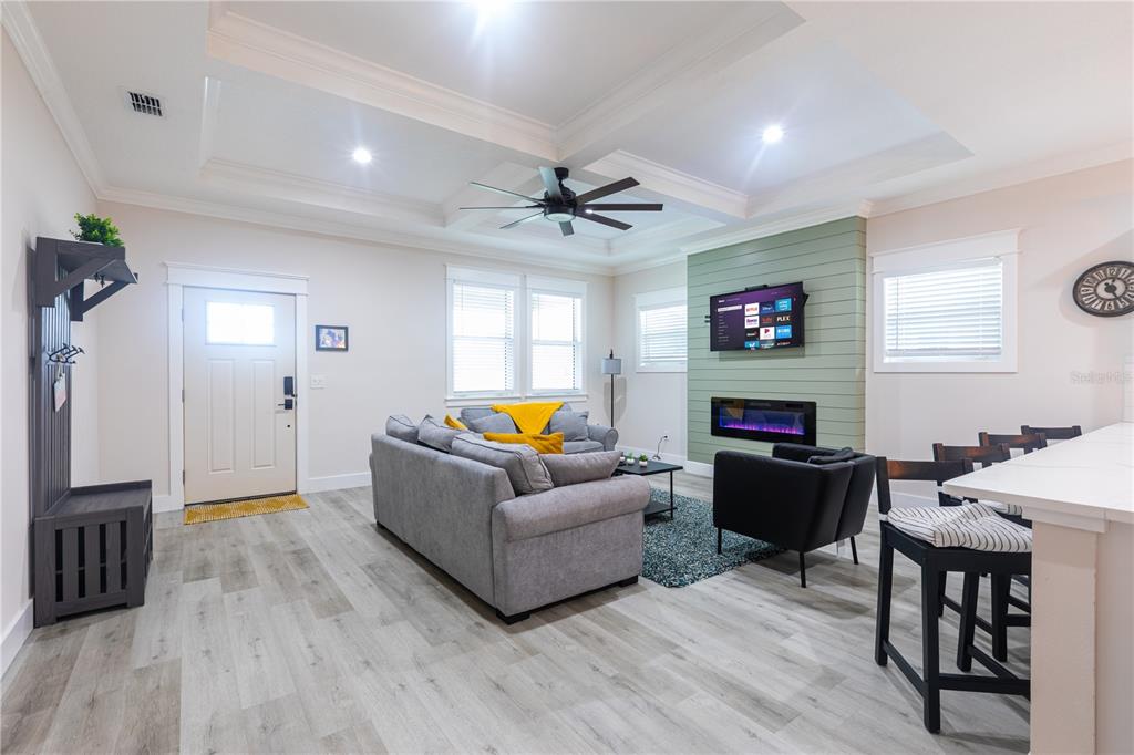 507 East Paris Street Tampa, FL 33604 - Photo 4 of 25 a living room with furniture a fireplace and a flat screen tv