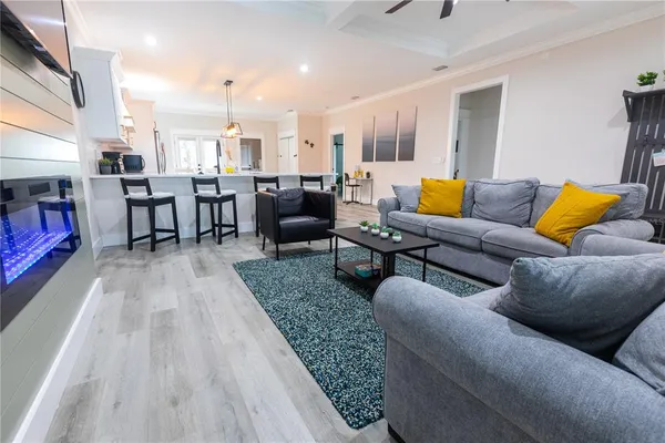 a living room with lots of furniture and a wooden floor