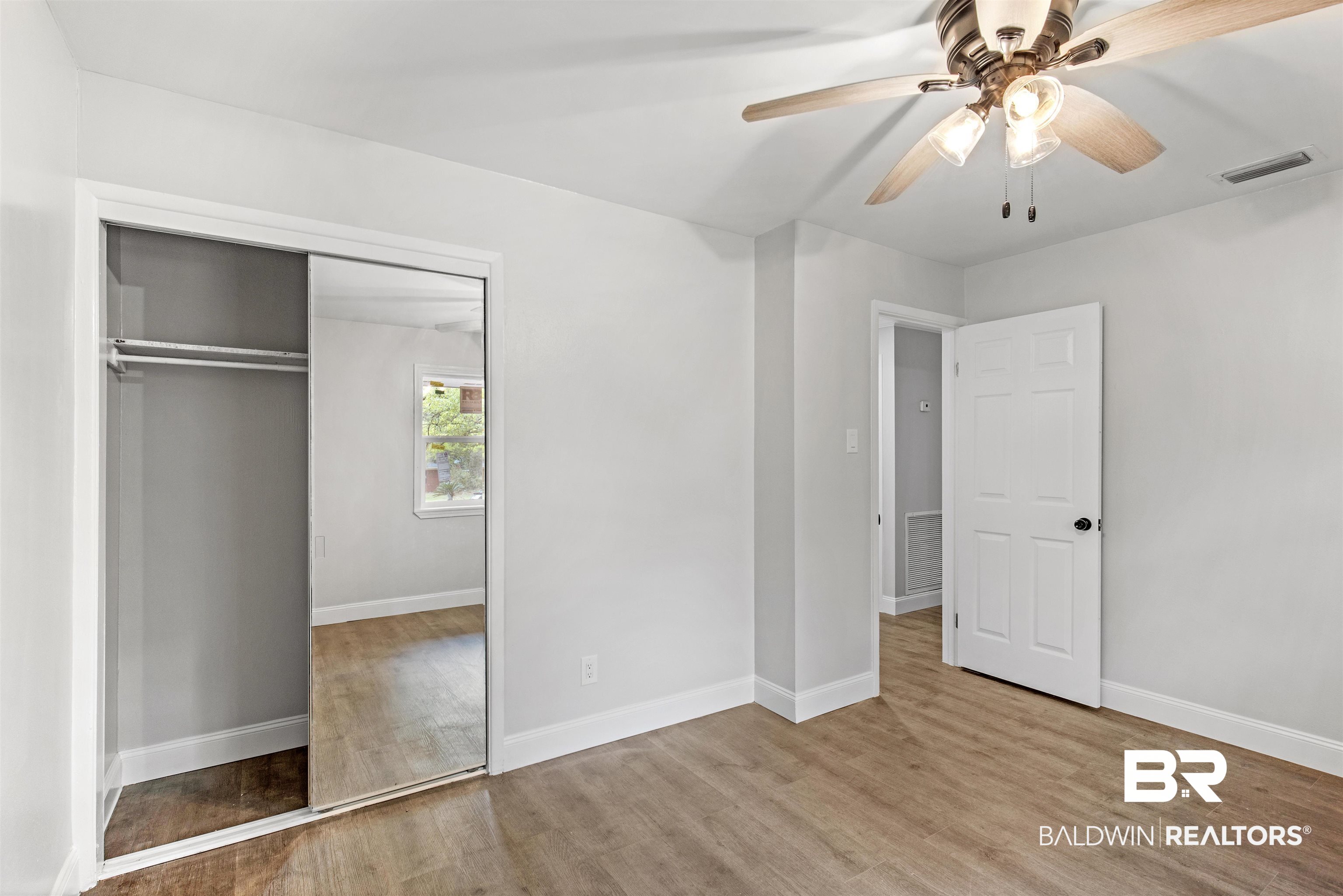 1432 South Polaris Drive Mobile, AL 36693 - Photo 10 of 27 Unfurnished bedroom with wood finished floors, a closet, and a ceiling fan