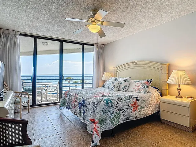 a bedroom with a bed and glass door