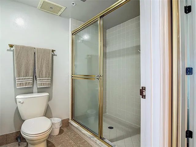 a bathroom with a toilet and shower