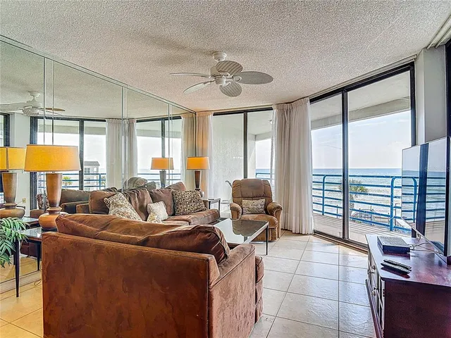 a living room with furniture and a floor to ceiling window