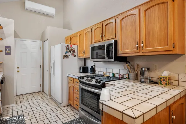 a kitchen with stainless steel appliances a stove a microwave and a sink