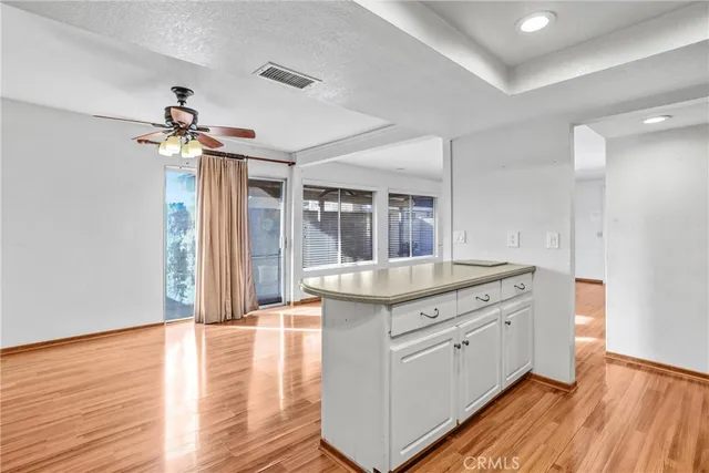 a kitchen with granite countertop a stove a sink and a refrigerator