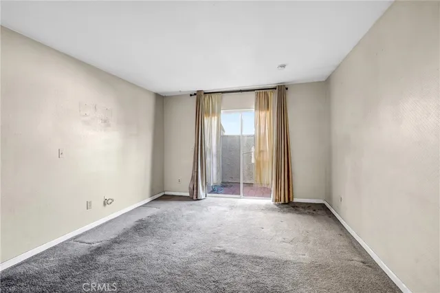 a view of an empty room and closet area