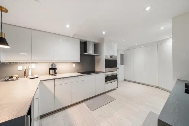a kitchen with granite countertop a sink and white cabinets