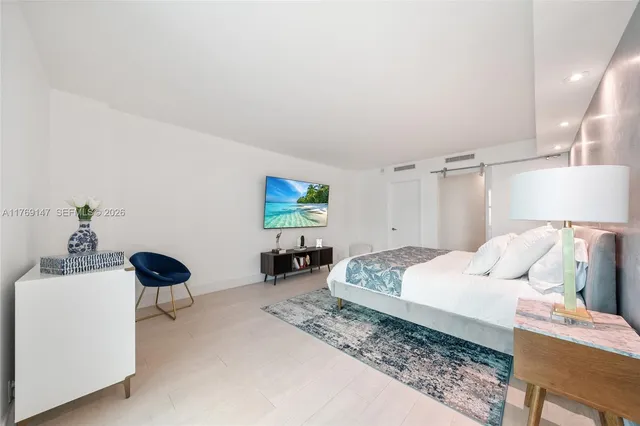 a bedroom with a bed and a chair