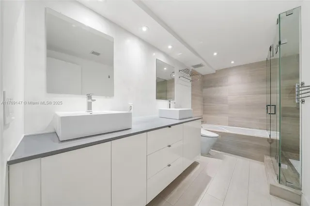 a bathroom with a shower sink and mirror