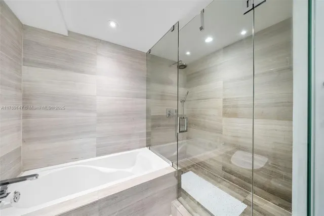 a bathroom with a bathtub and a shower