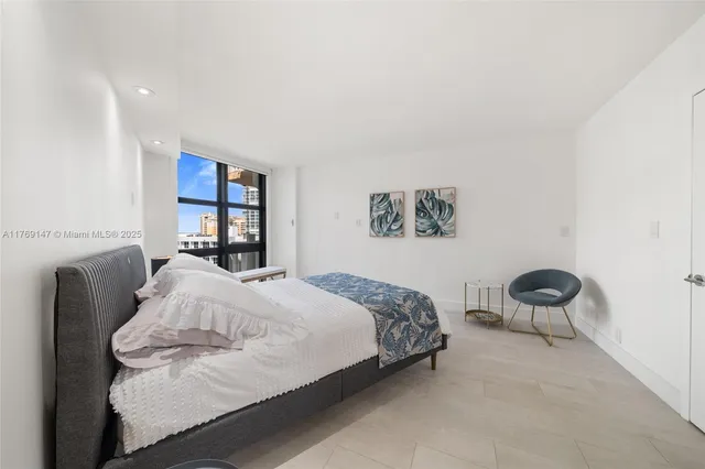 a bedroom with a bed and chair