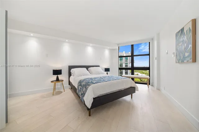 a spacious bedroom with a bed and a window