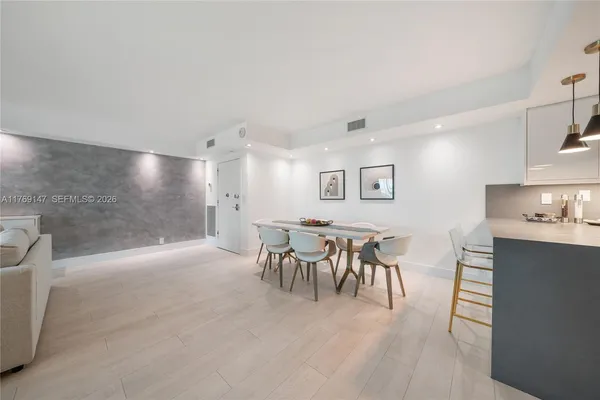 a view of a dining area with furniture and chandelier