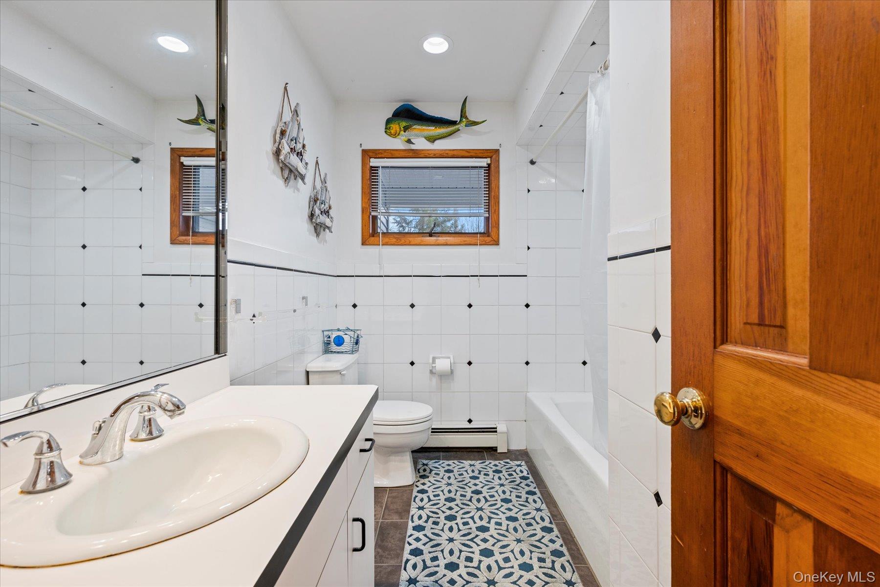 214 Pipe Stave Hollow Road Mount Sinai, NY 11766 - Photo 14 of 25 a bathroom with a sink and a mirror
