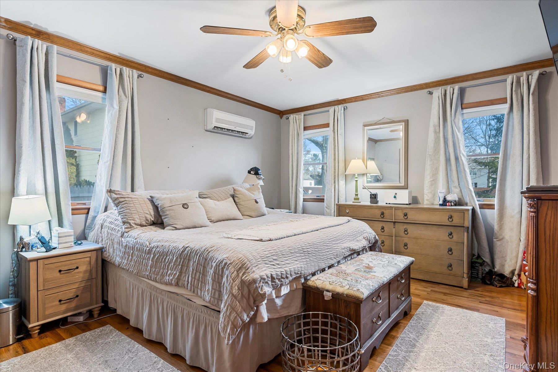 214 Pipe Stave Hollow Road Mount Sinai, NY 11766 - Photo 17 of 25 a bedroom with a bed and a dresser