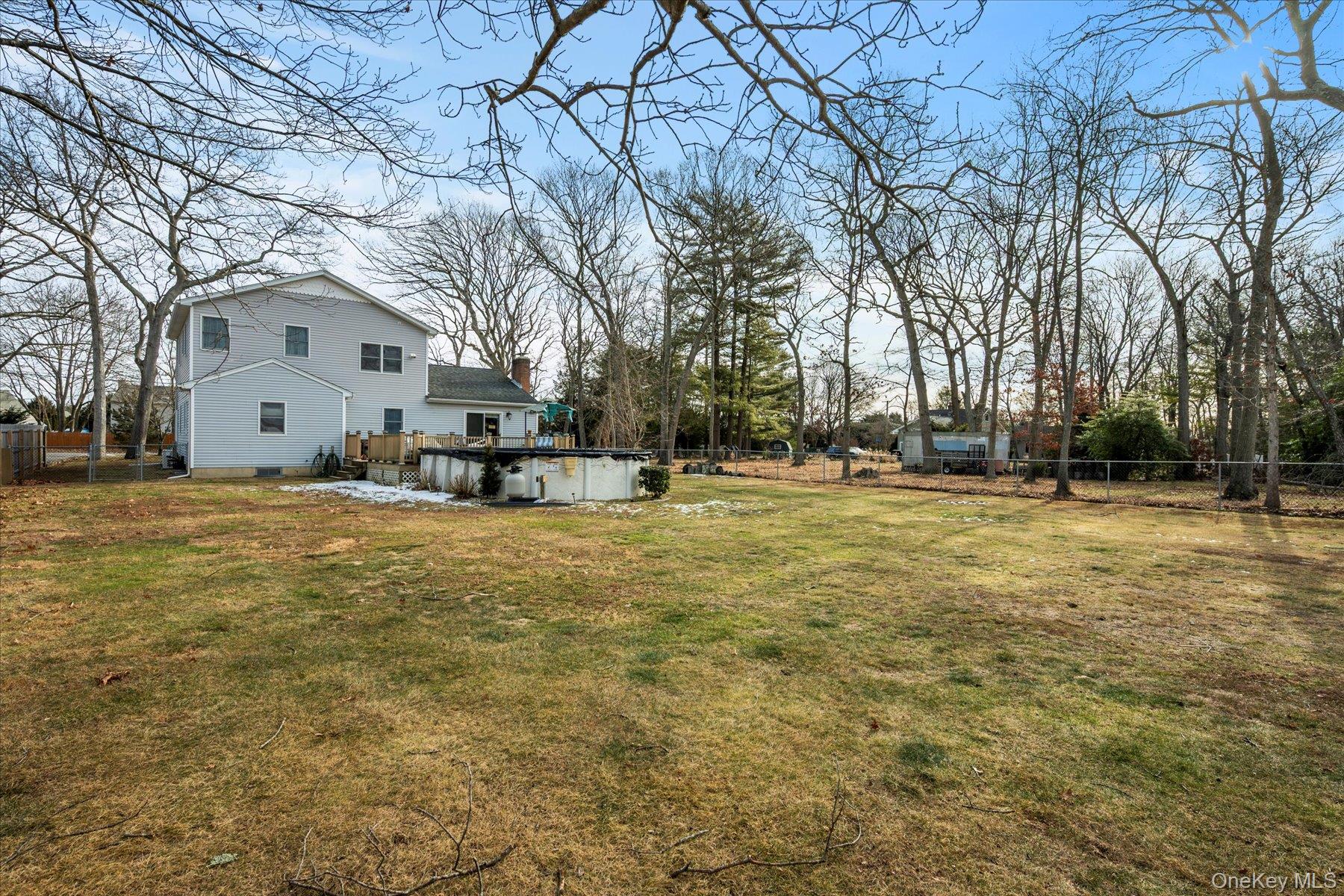 214 Pipe Stave Hollow Road Mount Sinai, NY 11766 - Photo 20 of 25 a front view of a house with a yard