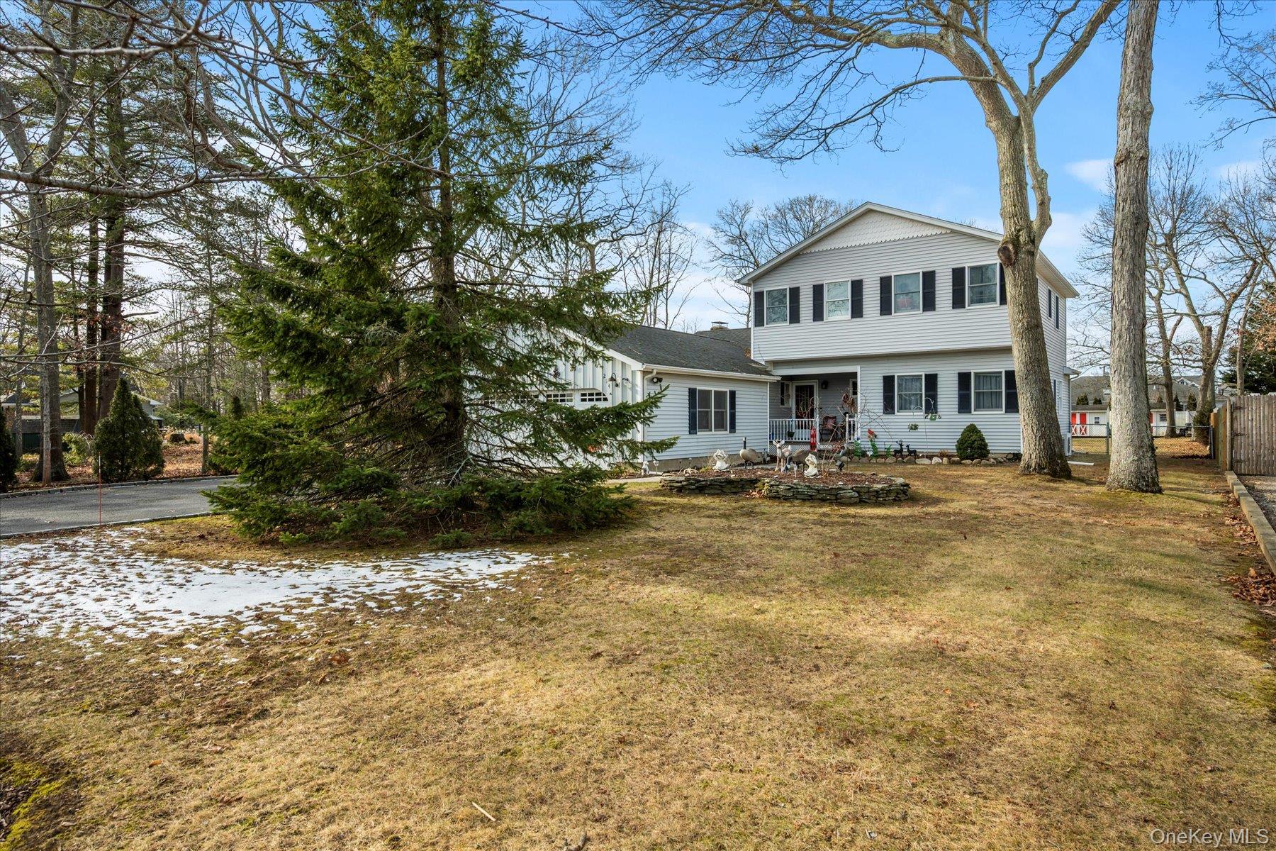 214 Pipe Stave Hollow Road Mount Sinai, NY 11766 - Photo 3 of 25 a front view of a building with a yard