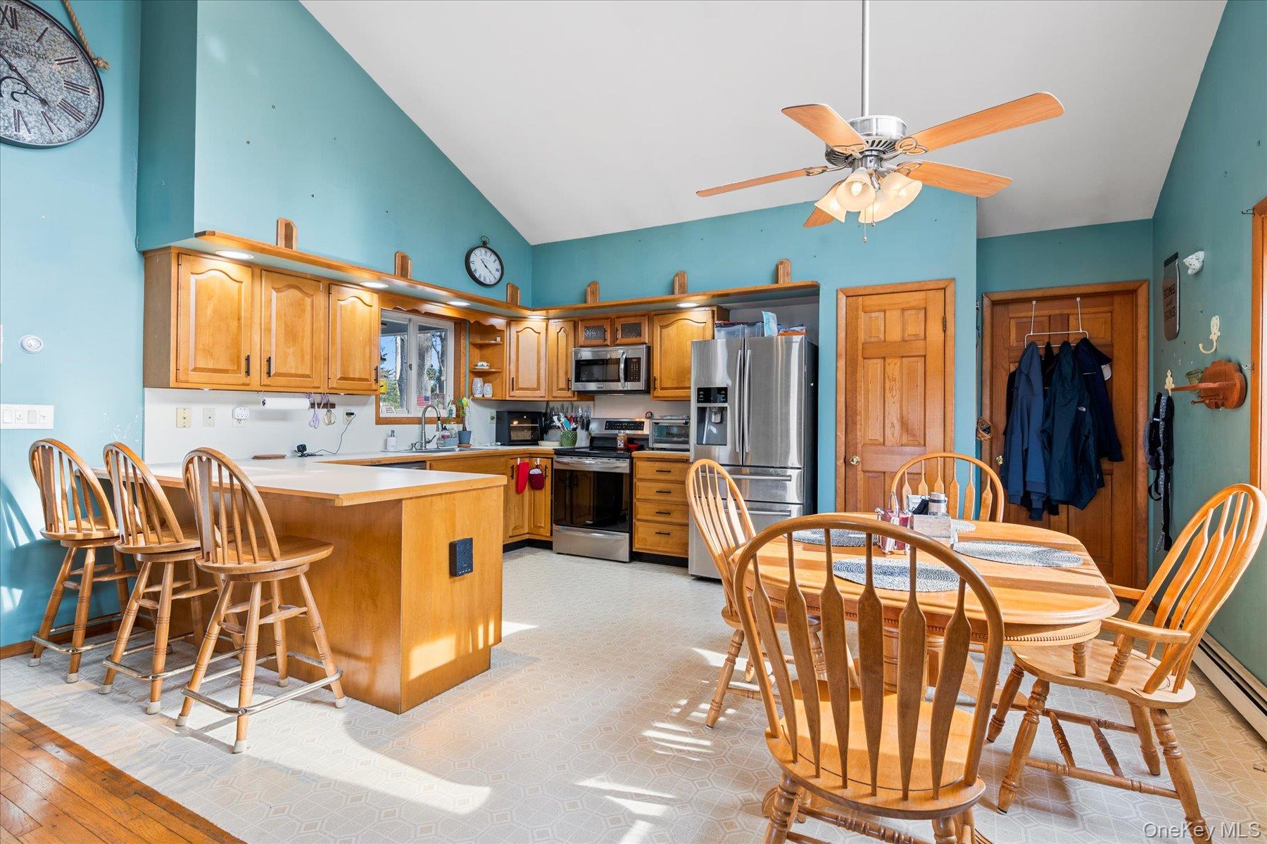214 Pipe Stave Hollow Road Mount Sinai, NY 11766 - Photo 24 of 25 a dining room with furniture a chandelier and wooden floor