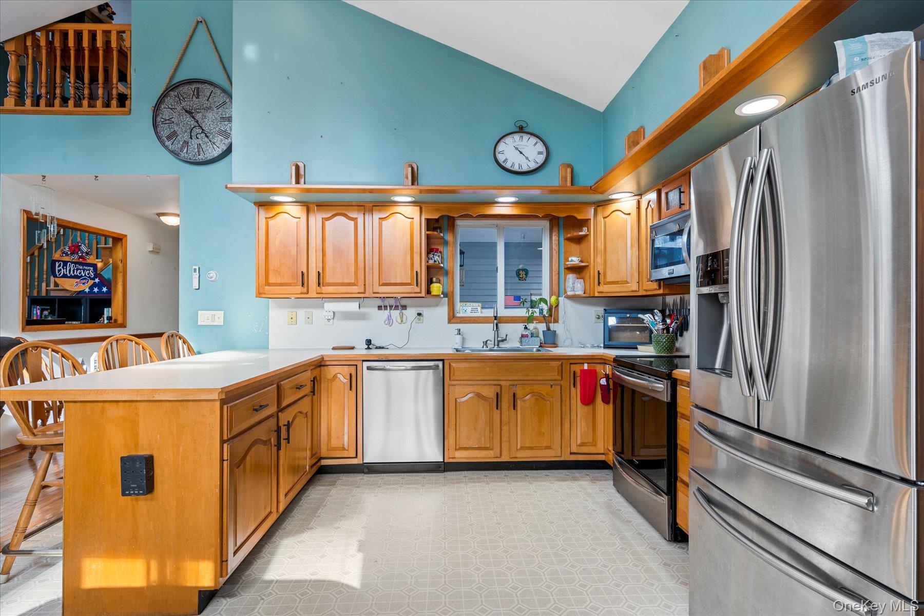 214 Pipe Stave Hollow Road Mount Sinai, NY 11766 - Photo 5 of 25 a kitchen with stainless steel appliances granite countertop a refrigerator and a stove