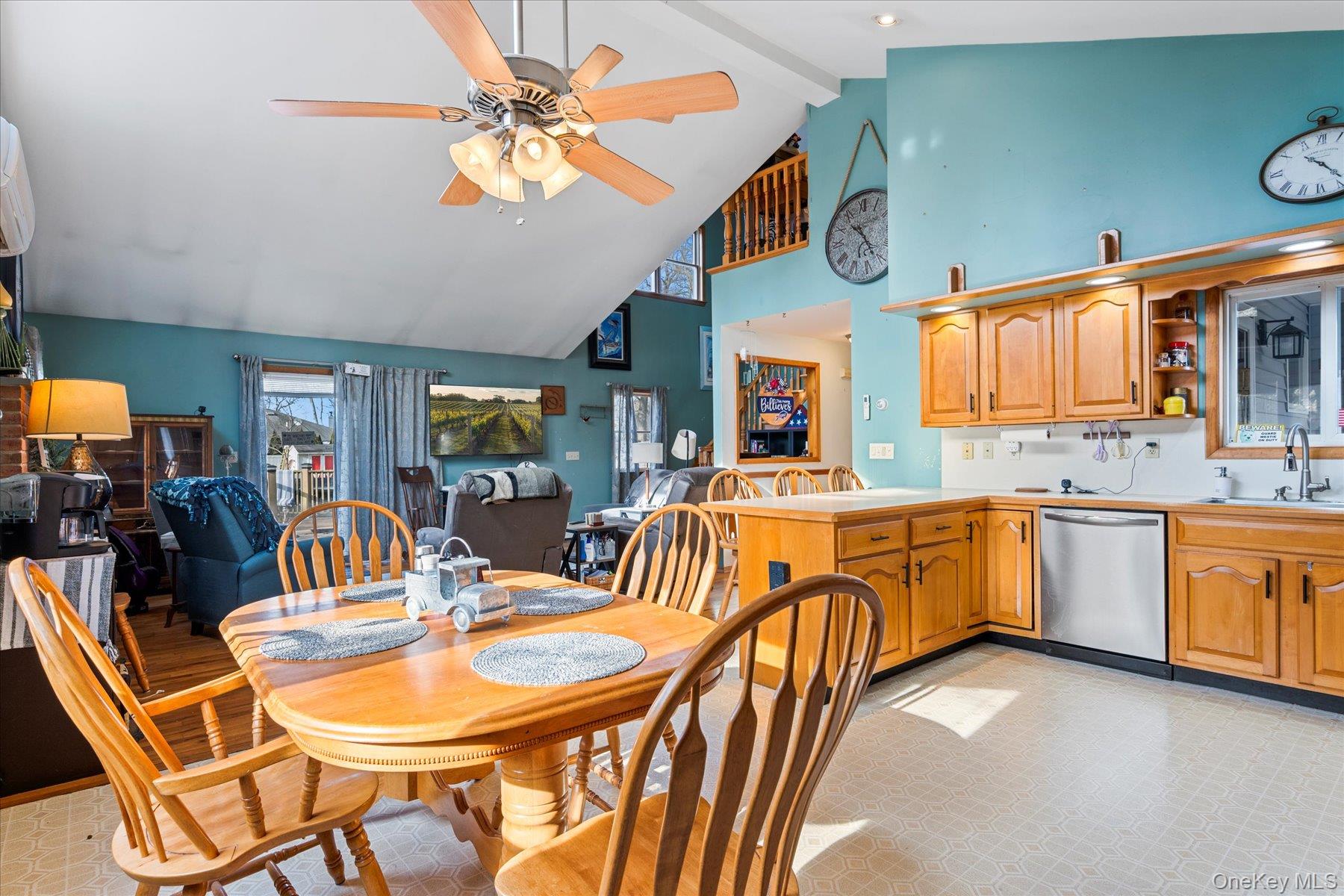 214 Pipe Stave Hollow Road Mount Sinai, NY 11766 - Photo 25 of 25 a dining hall with stainless steel appliances granite countertop a sink a stove a dining table and chairs with wooden floor