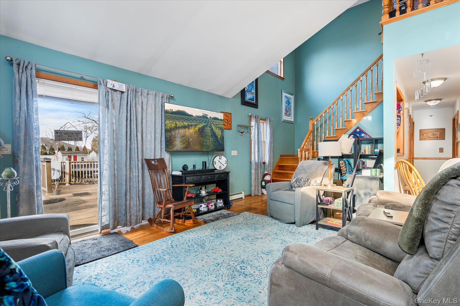 214 Pipe Stave Hollow Road Mount Sinai, NY 11766 - Photo 7 of 25 a living room with furniture and a flat screen tv