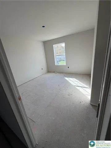 a view of an empty room and a window