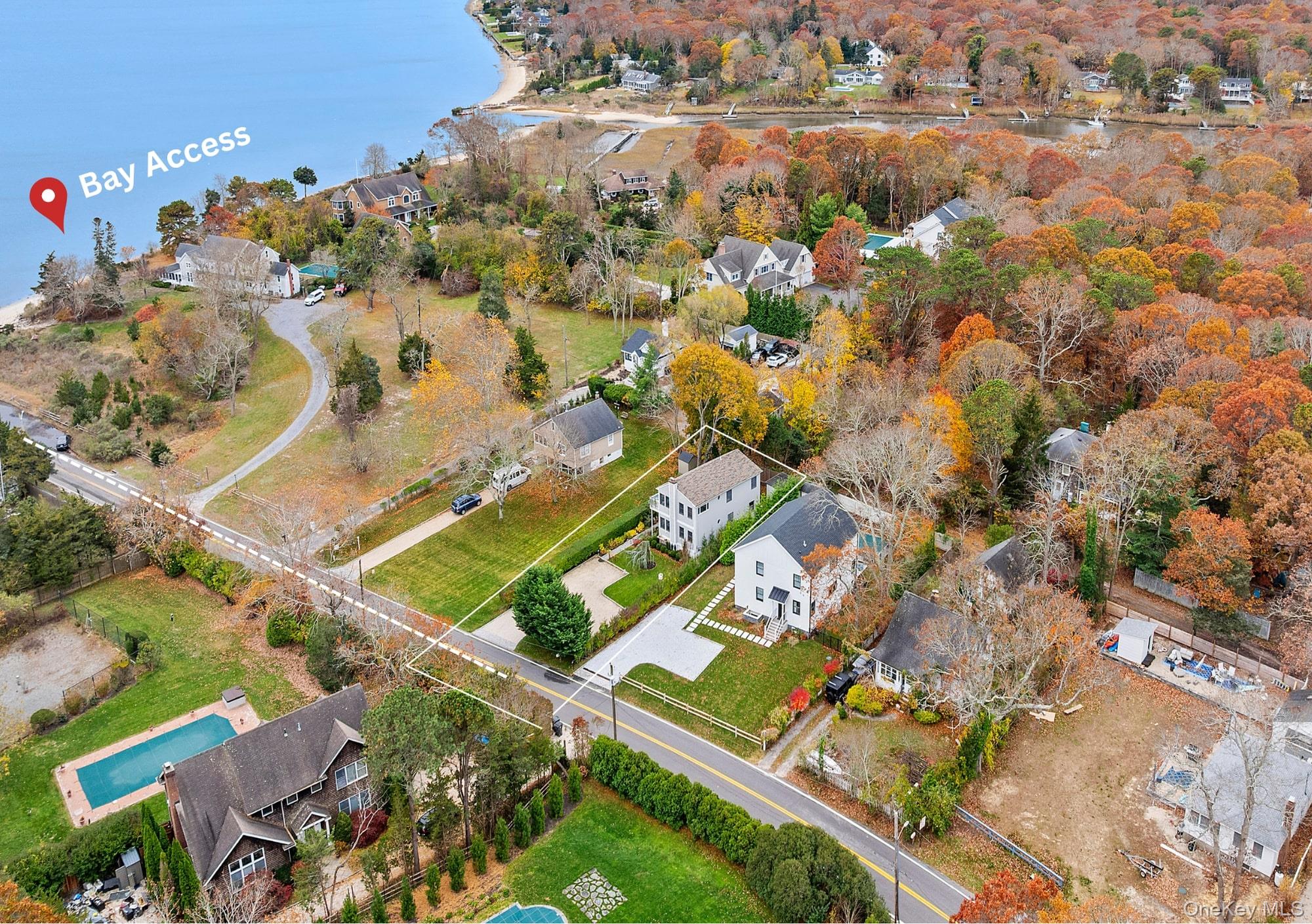 Aerial view of property's location featuring nearby suburban area and a nearby body of water