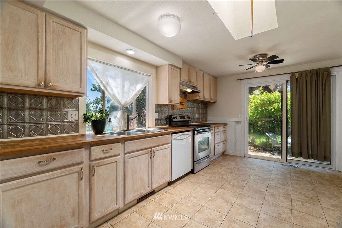 18135 Tamara Lane Southwest Rochester, WA 98579 - Photo 8 of 20 a kitchen with a white cabinets and window