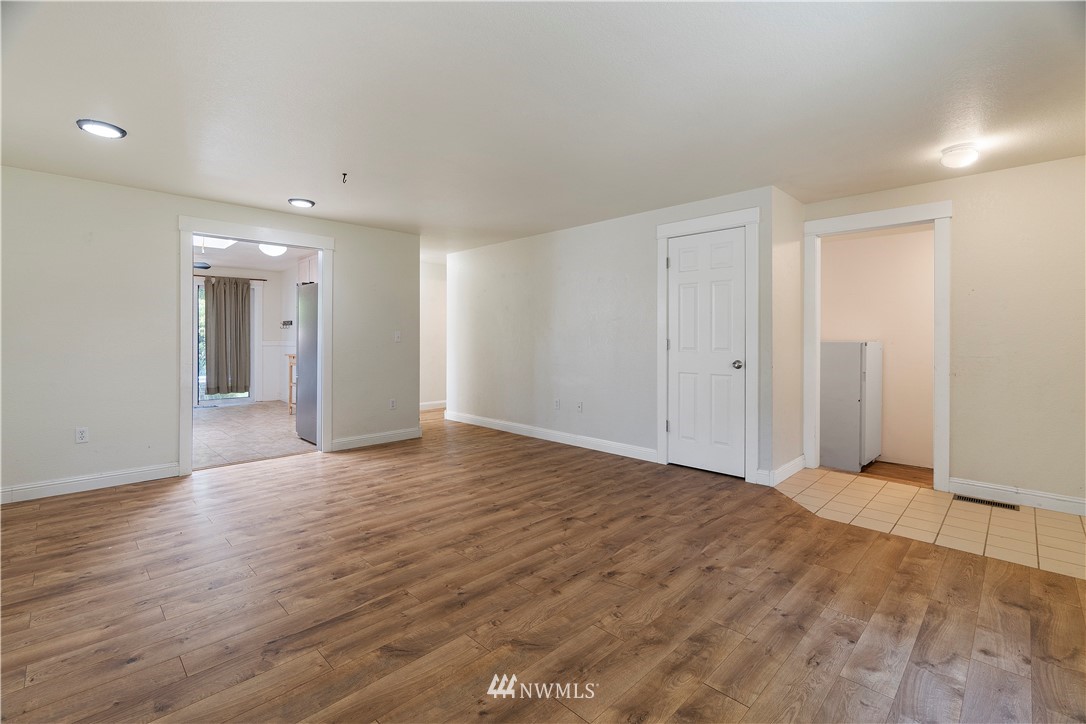 18135 Tamara Lane Southwest Rochester, WA 98579 - Photo 9 of 20 wooden floor in an empty room with a window