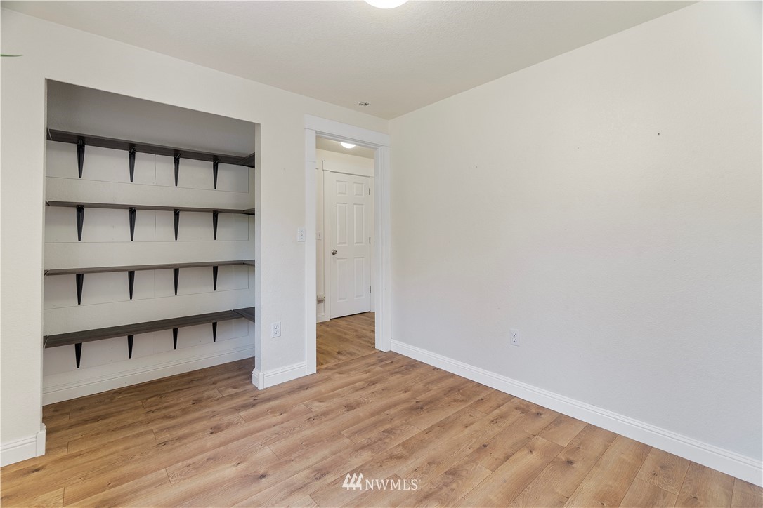 18135 Tamara Lane Southwest Rochester, WA 98579 - Photo 10 of 20 a view of a room with wooden floor and cabinet