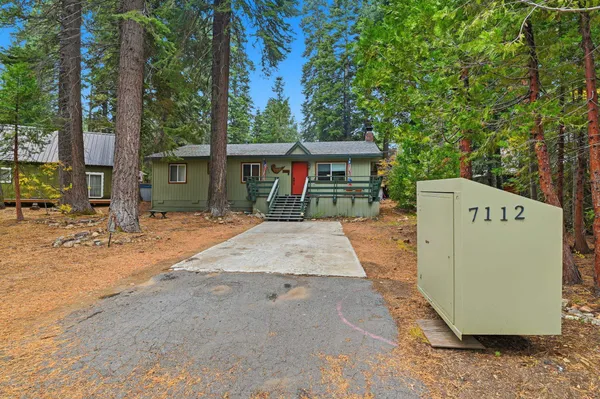 a view of a house with backyard and sitting area