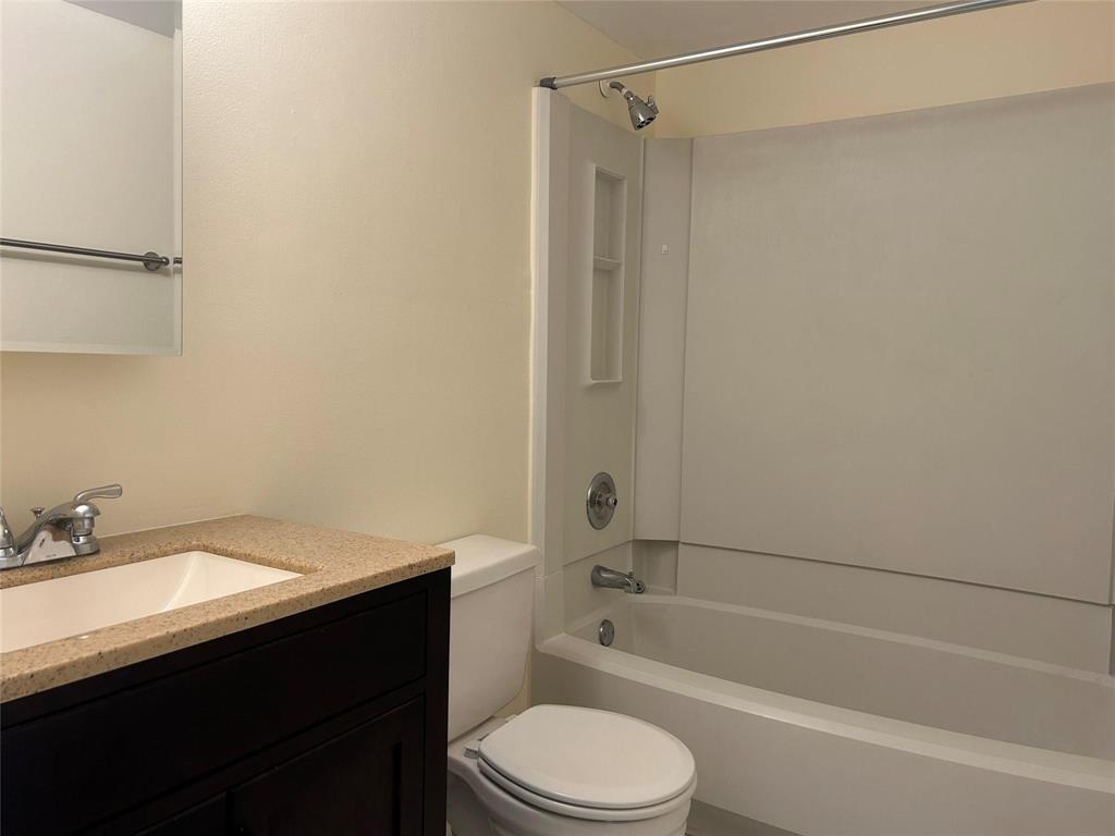 2401 Riverside Drive, Unit 308 Coral Springs, FL 33065 - Photo 11 of 15 a bathroom with a sink a toilet and shower