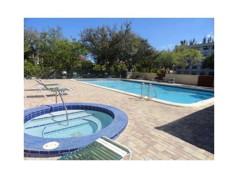 2401 Riverside Drive, Unit 308 Coral Springs, FL 33065 - Photo 14 of 15 a view of a swimming pool with a yard