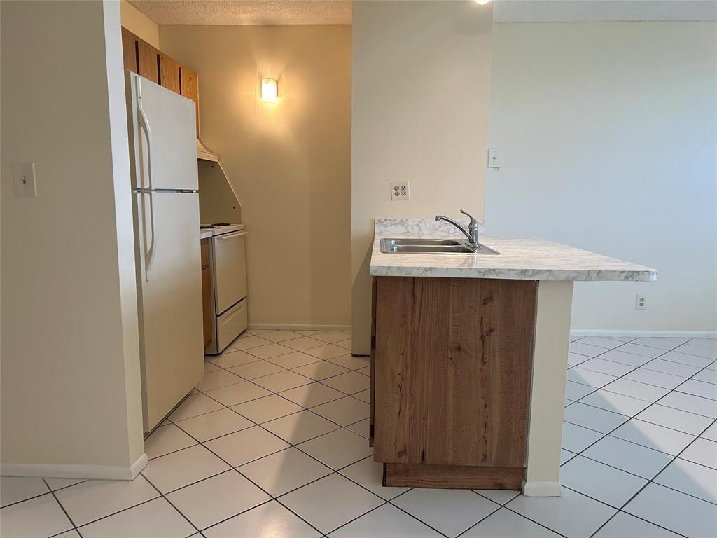 2401 Riverside Drive, Unit 308 Coral Springs, FL 33065 - Photo 3 of 15 a utility room with cabinets