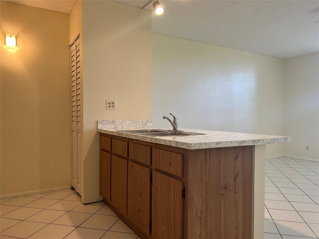 2401 Riverside Drive, Unit 308 Coral Springs, FL 33065 - Photo 7 of 15 a bathroom with a sink and vanity